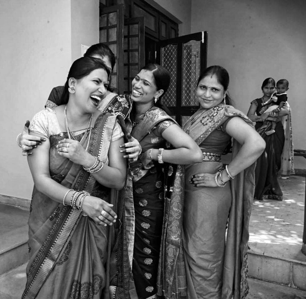 Women at Leisure: Women enjoying time together on Hartalika Teej, a Hindu festival. Another spends time taking care of one of their babies.