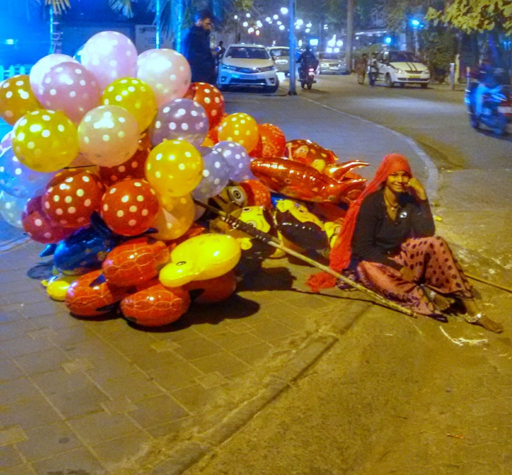 Women at Leisure: A balloon seller takes a break after a long day of walking to different markets
