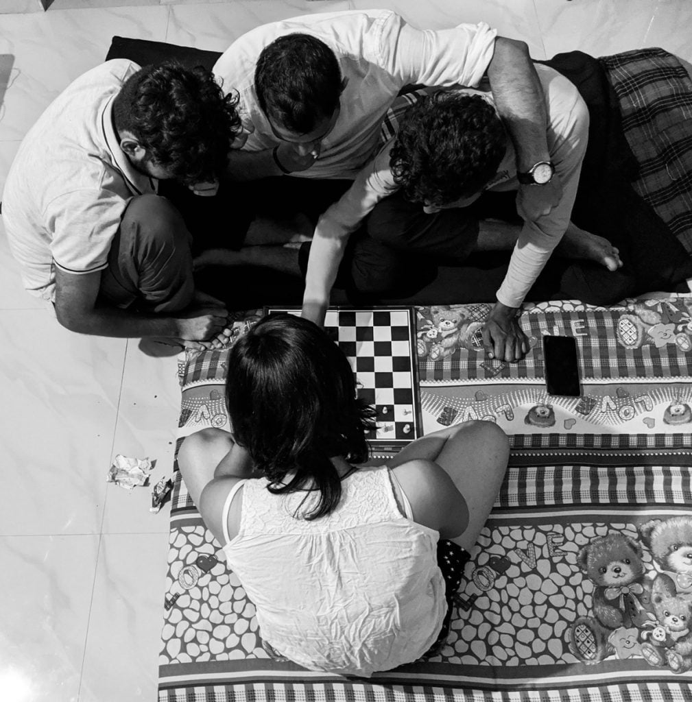 Women at Leisure: Zeba is playing chess against three of her friends. 