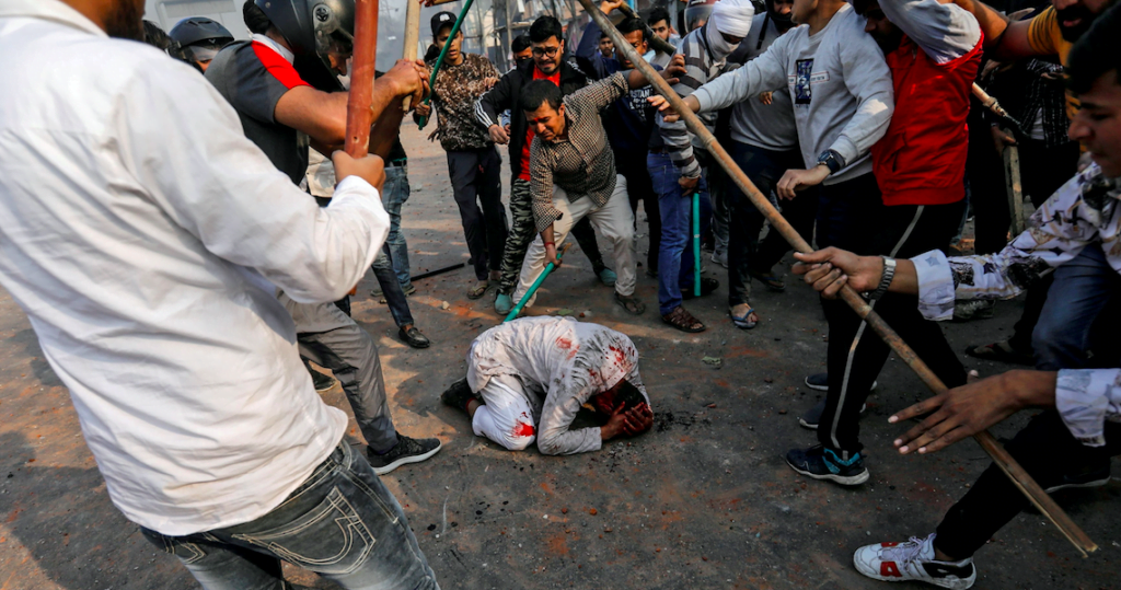 Photo of a Muslim Man Being Beaten in Delhi Riots