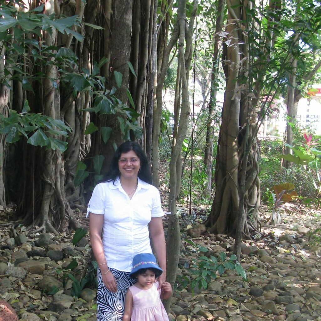 Dr Harini , a writer and ecologist standing with a little girl  