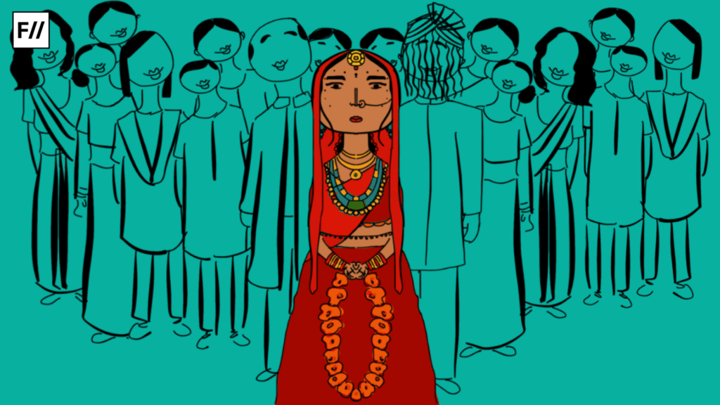 An Indian marriage with bride in front of the image wearing red dress