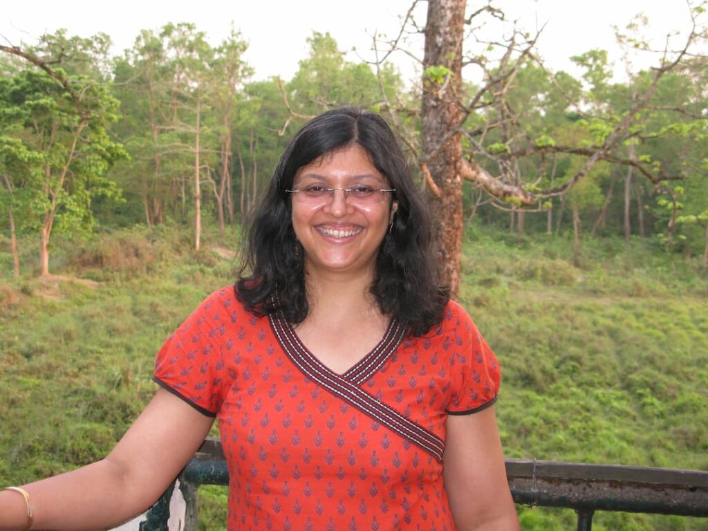 Dr Harini , a writer and ecologist, standing near trees
