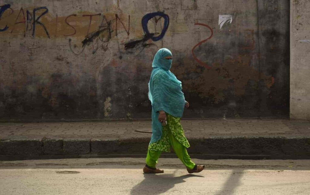 Kashmiri woman walking alone on the road 