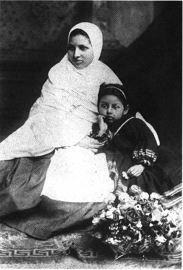 Pandita Ramabai sitting with a kid with roses in front. 