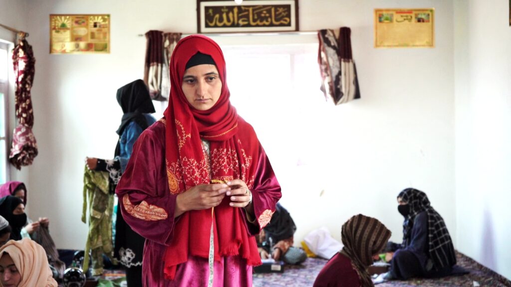 Gujjar woman learning the art and craft of traditional Gujjar attire.