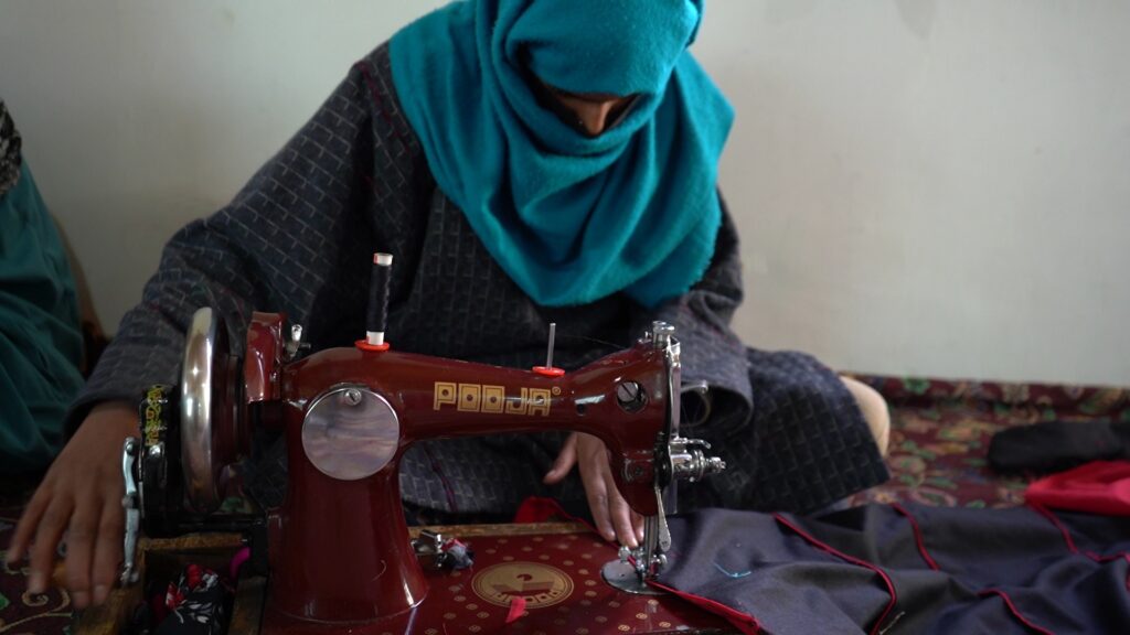 Gujjar woman learning the art and craft of traditional Gujjar attire.