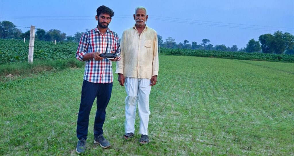 Ashish Beniwal spraying pesticides with a drone in a field in a village in Hanumangarh distric