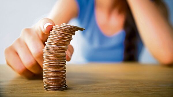 Woman touching a tower of coins