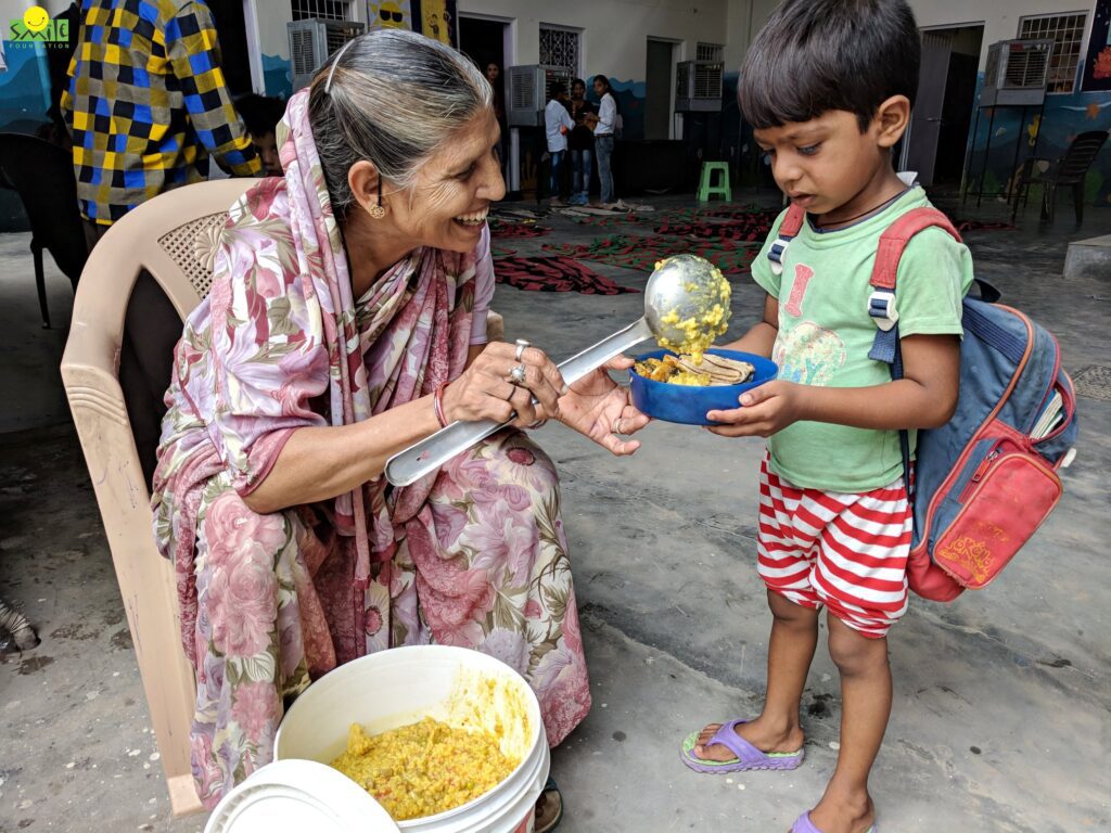 Woman serving food to a child