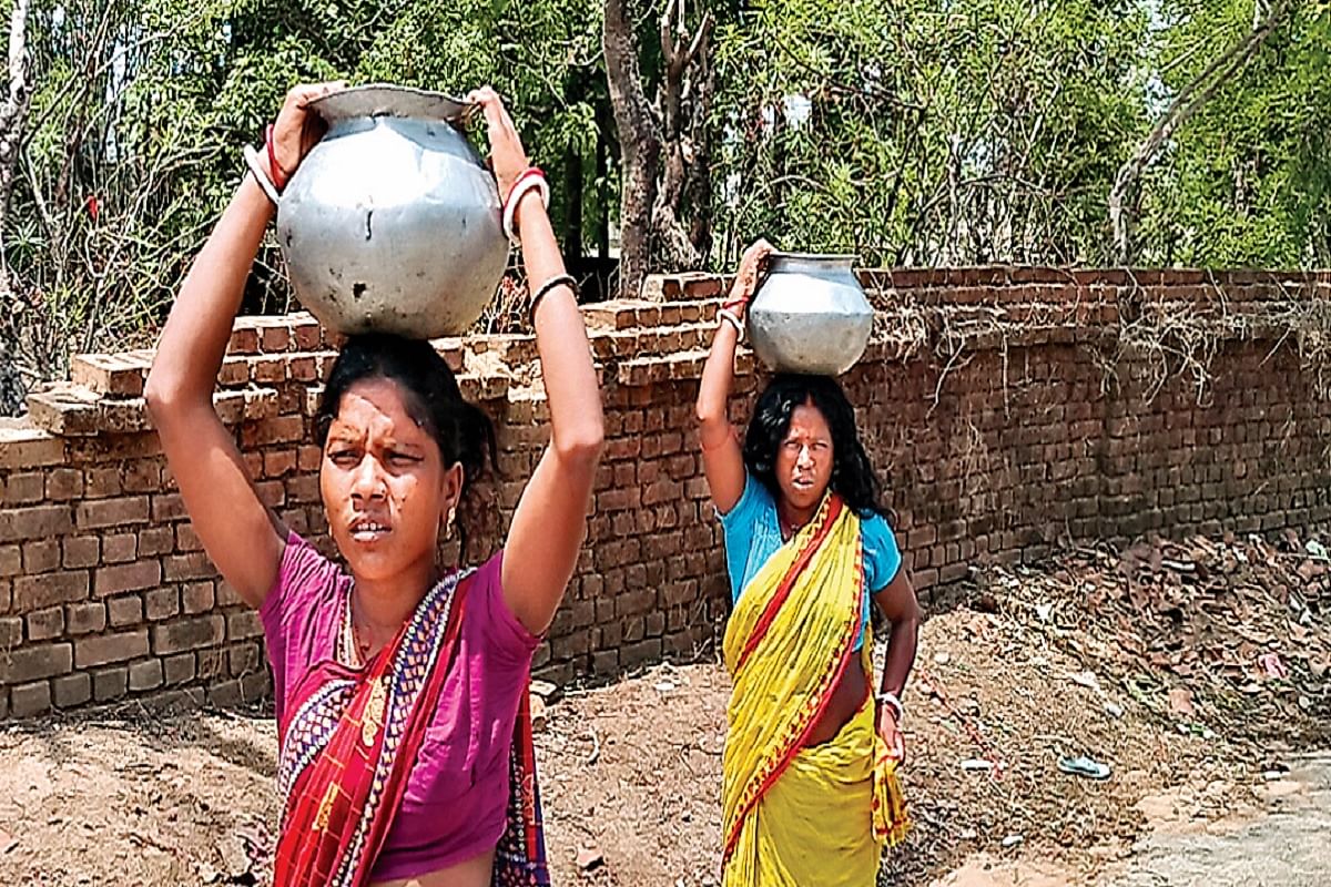 Two women with water pots on their heads