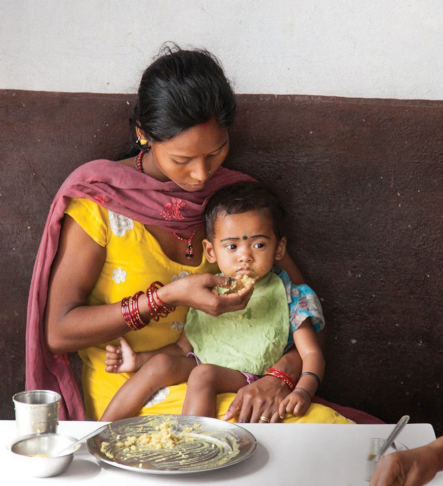 Woman feeding child