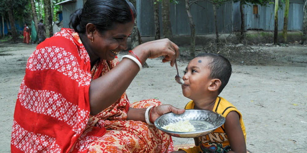 Woman feeding child