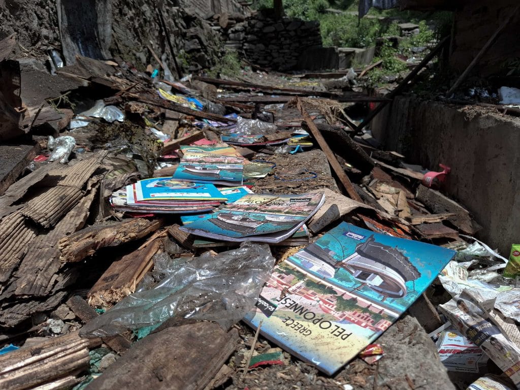 A fresh notebook lies under the debris of a collapsed shop in Uri village, Baramulla district. Credit: Umer Farooq