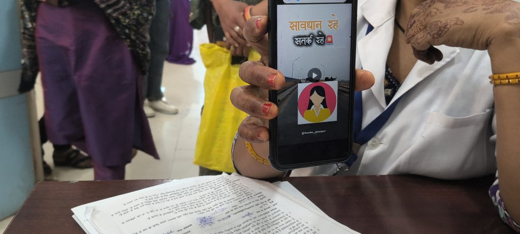 ANM Sushila Vijayvargiya at Rajgarh District Hospital displays a viral video spreading vaccine misinformation on her mobile.