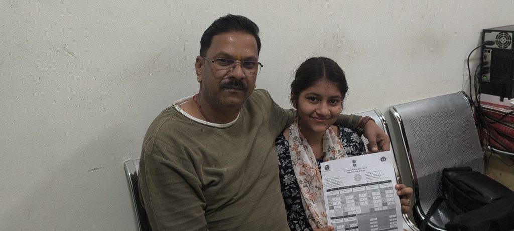 Jitendra Songira with his daughter Kashi Songira after she received the HPV vaccine in Rajgarh.